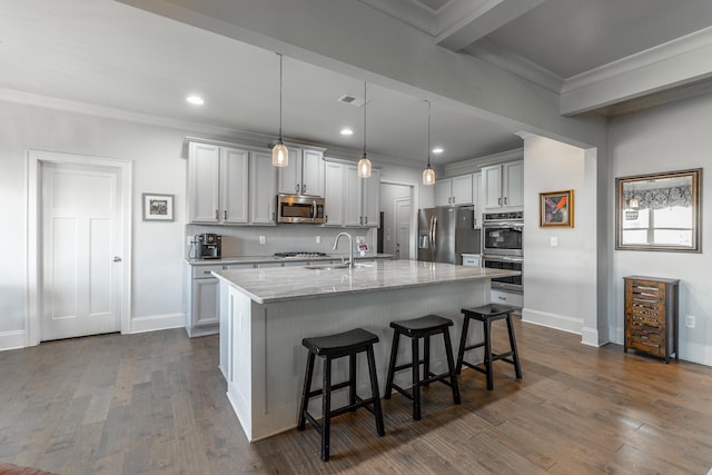 kitchen with backsplash, a breakfast bar area, stainless steel appliances, and ornamental molding