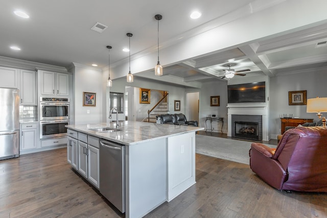 kitchen with a sink, visible vents, appliances with stainless steel finishes, and open floor plan