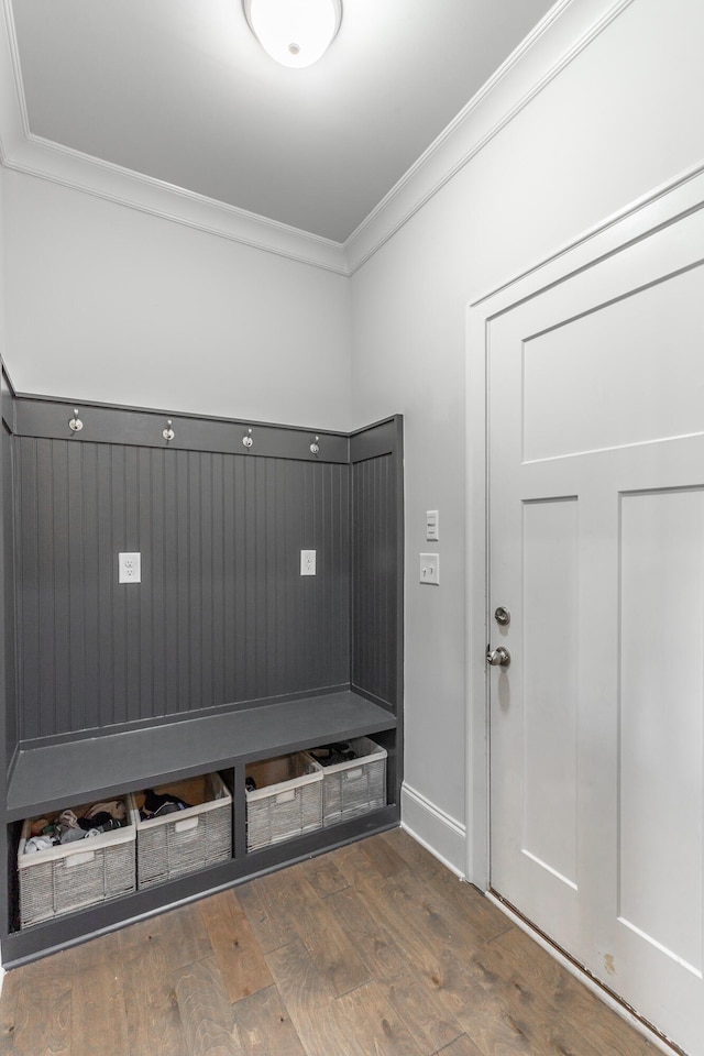 mudroom with wood finished floors and ornamental molding