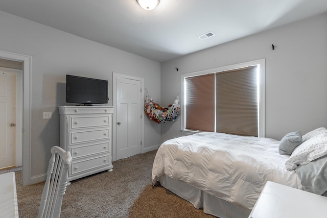 carpeted bedroom with baseboards and visible vents