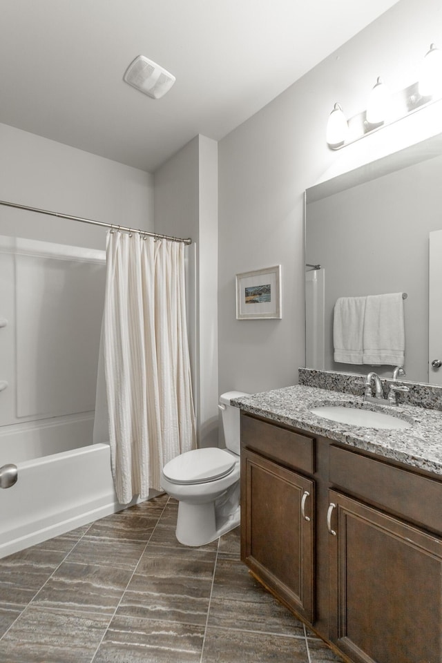 full bathroom featuring vanity, toilet, visible vents, and shower / tub combo with curtain