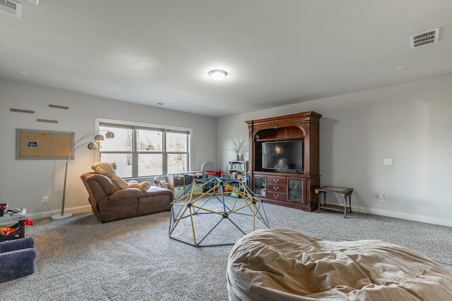 living area featuring visible vents, carpet, and baseboards