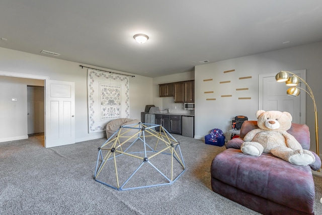 living room with visible vents, baseboards, and carpet