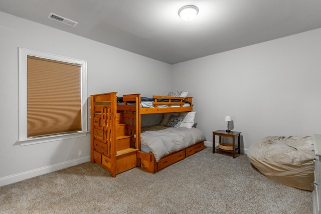 carpeted bedroom with visible vents and baseboards