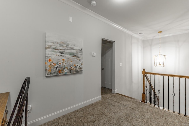 corridor featuring an upstairs landing, carpet flooring, baseboards, and ornamental molding