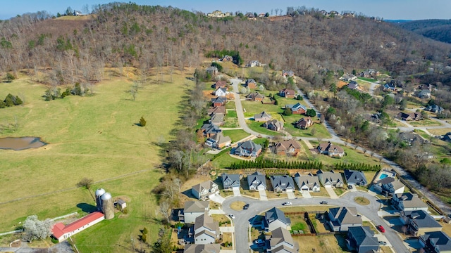 birds eye view of property featuring a wooded view and a residential view