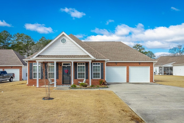 view of front facade featuring an attached garage, brick siding, driveway, roof with shingles, and a front yard