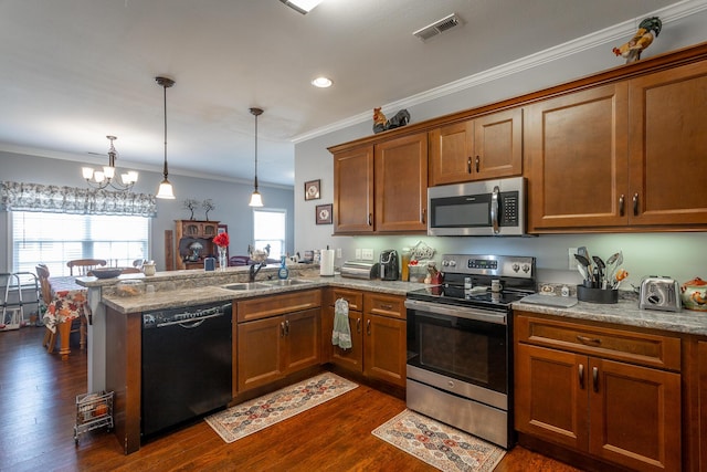 kitchen with a peninsula, a sink, visible vents, appliances with stainless steel finishes, and brown cabinets