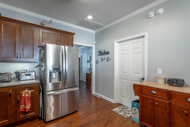 kitchen featuring dark wood-type flooring, baseboards, light countertops, ornamental molding, and stainless steel refrigerator with ice dispenser