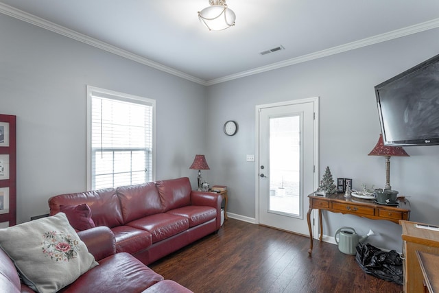 living area featuring ornamental molding, wood-type flooring, visible vents, and baseboards