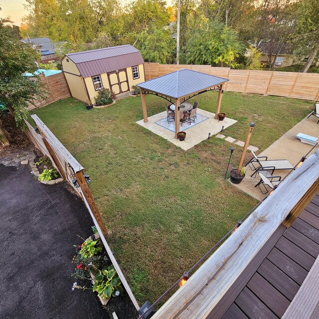 view of yard with an outbuilding, a patio area, and a fenced backyard