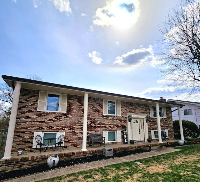 split foyer home with brick siding