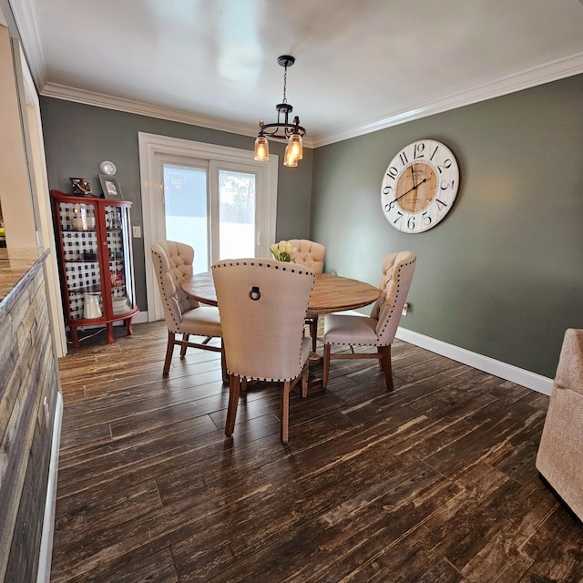 dining space with dark wood-style floors, ornamental molding, a chandelier, and baseboards