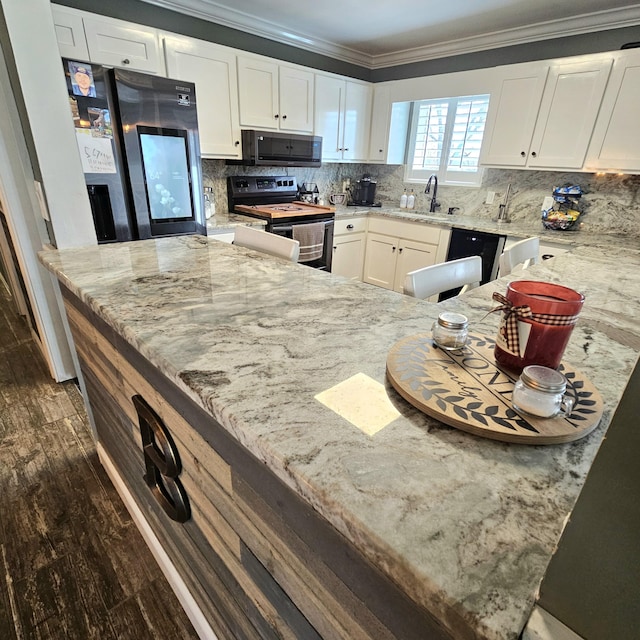 kitchen featuring light stone counters, range with electric cooktop, a sink, and crown molding