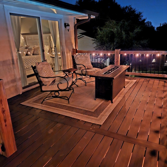 deck at night with a fire pit