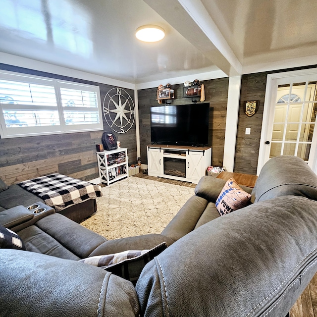 living area with a fireplace and wooden walls