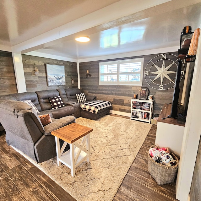 living room with dark wood-style flooring and wooden walls