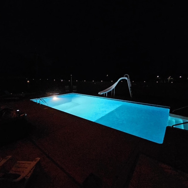 pool at night with a water slide