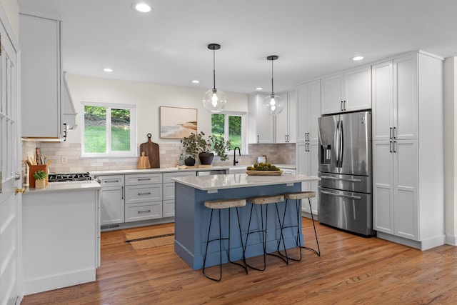 1723 Hixson Pike, Chattanooga, TN 37405 - kitchen featuring light countertops, appliances with stainless steel finishes, decorative backsplash, and a breakfast bar area