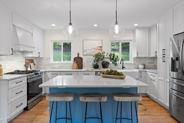 1723 Hixson Pike, Chattanooga, TN 37405 - kitchen with appliances with stainless steel finishes, custom range hood, a kitchen bar, and a wealth of natural light