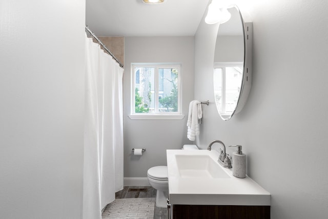 1723 Hixson Pike, Chattanooga, TN 37405 - bathroom with toilet, baseboards, wood finished floors, and vanity