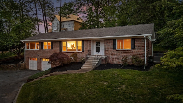 1723 Hixson Pike, Chattanooga, TN 37405 - single story home with driveway, central air condition unit, brick siding, a yard, and an attached garage