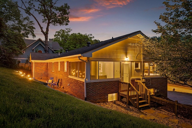 1723 Hixson Pike, Chattanooga, TN 37405 - rear view of property with a lawn, brick siding, and a sunroom