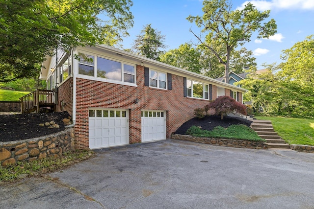 1723 Hixson Pike, Chattanooga, TN 37405 - view of front facade with stairs, a garage, driveway, and brick siding