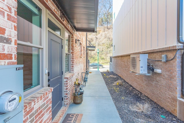 view of property exterior with brick siding and ac unit