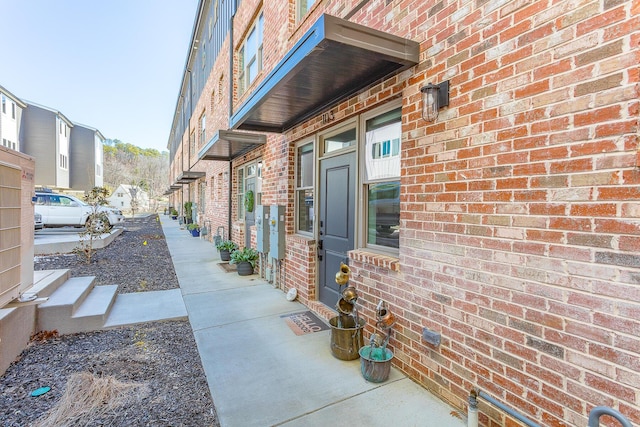 view of side of property featuring brick siding and a residential view