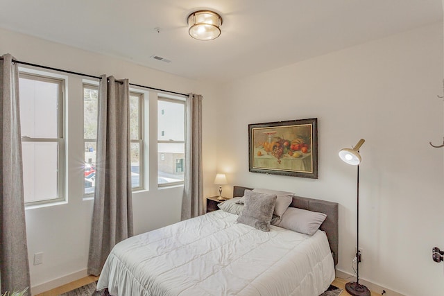 bedroom featuring visible vents and baseboards