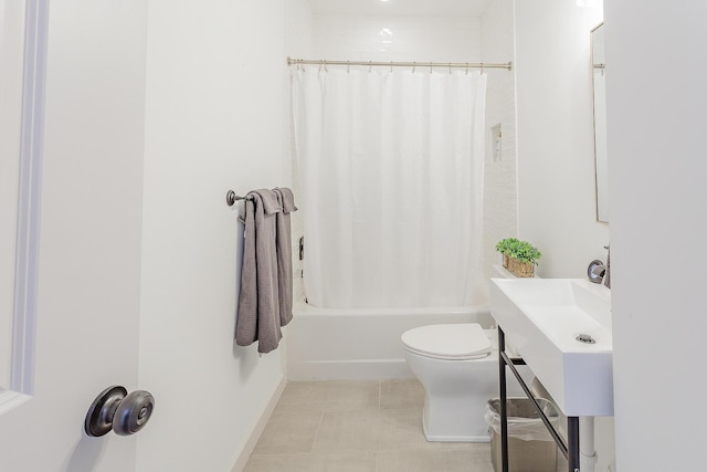 full bath featuring shower / tub combo, toilet, and tile patterned floors