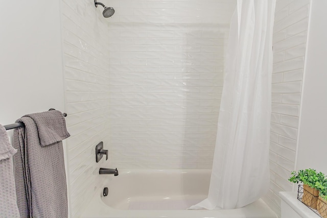 bathroom featuring shower / bath combo and toilet