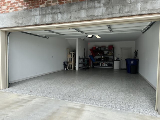 garage featuring a garage door opener and baseboards