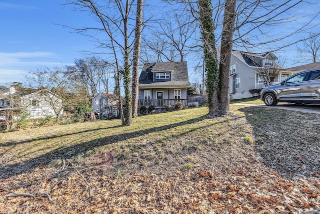 view of front of property with covered porch and a front yard