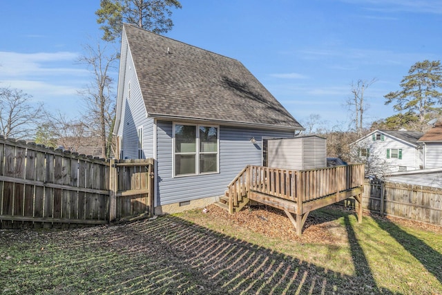 back of house featuring a shingled roof, fence, a yard, crawl space, and a wooden deck