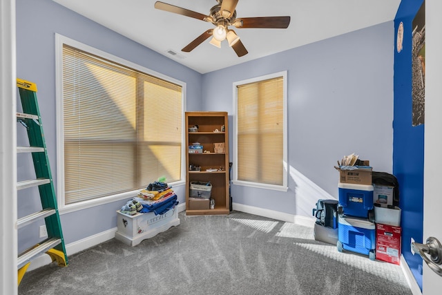 misc room with carpet floors, visible vents, ceiling fan, and baseboards