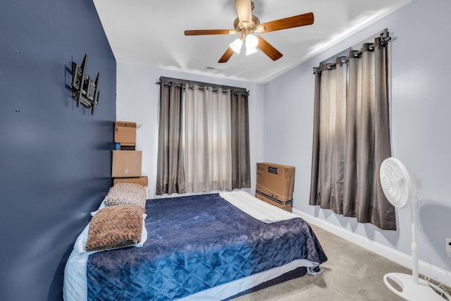 bedroom featuring carpet floors, heating unit, ceiling fan, and baseboards