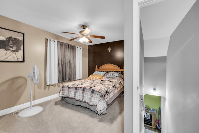 carpeted bedroom with a ceiling fan and baseboards