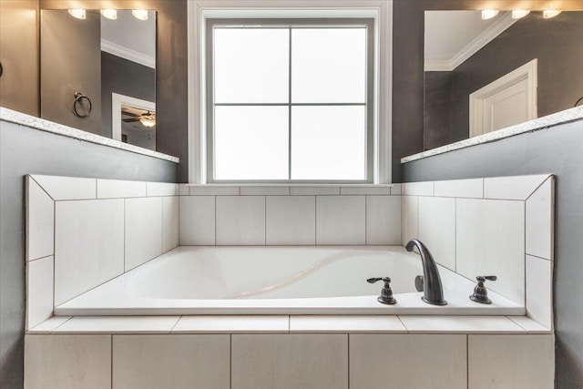 bathroom featuring a bath and crown molding