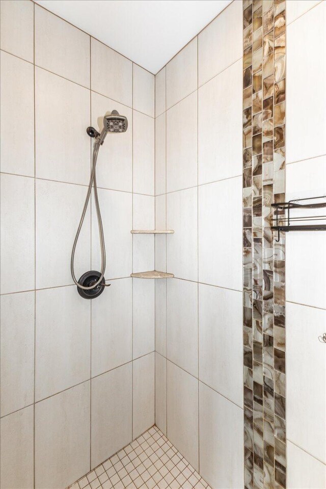 bathroom with tiled shower