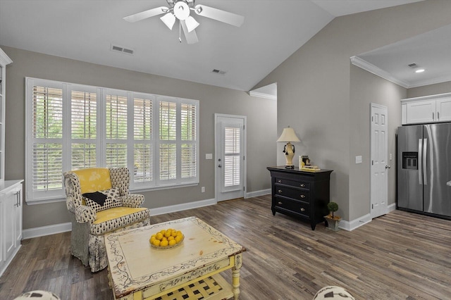 living area with dark wood-type flooring, visible vents, vaulted ceiling, and baseboards