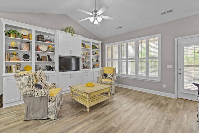 sitting room with lofted ceiling, light wood-style floors, ceiling fan, and visible vents