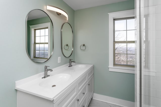 full bathroom featuring double vanity, baseboards, marble finish floor, and a sink