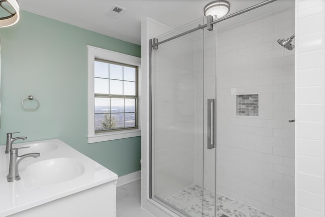 full bathroom featuring visible vents, a stall shower, and a sink