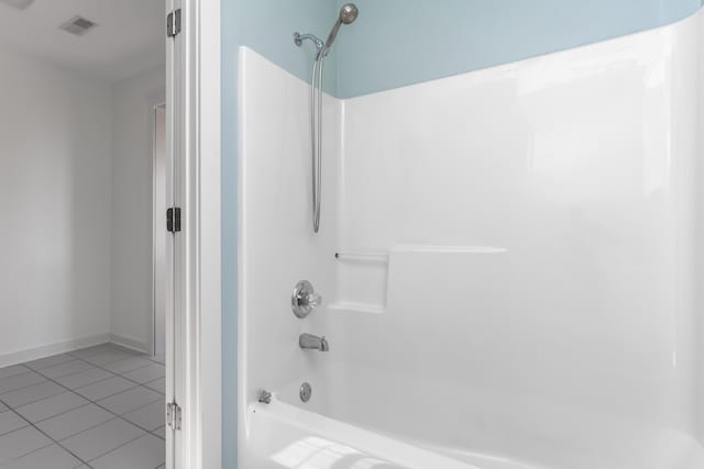 full bath featuring tile patterned flooring, tub / shower combination, visible vents, and baseboards