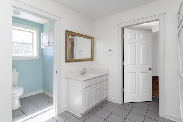 bathroom featuring tile patterned floors, toilet, vanity, and baseboards