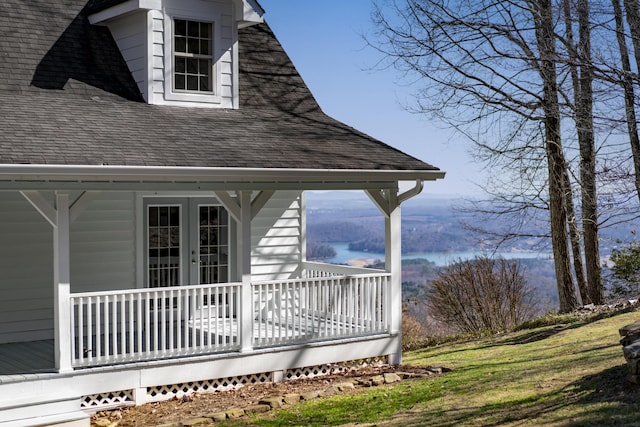 wooden deck featuring french doors and a water view