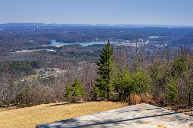 exterior space featuring a water view and a wooded view