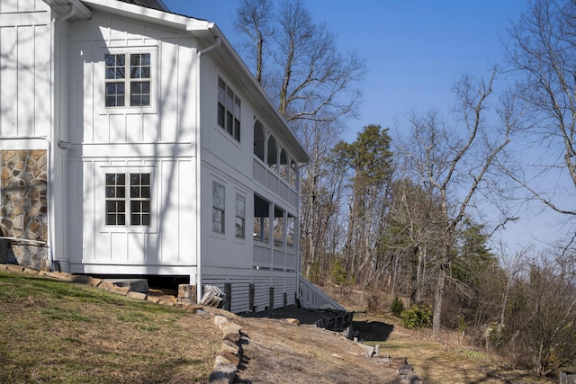 view of property exterior with stone siding and board and batten siding